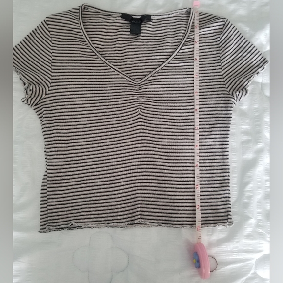 Small, light pink, light grey, white and black ruffly top. - Picture 3 of 9